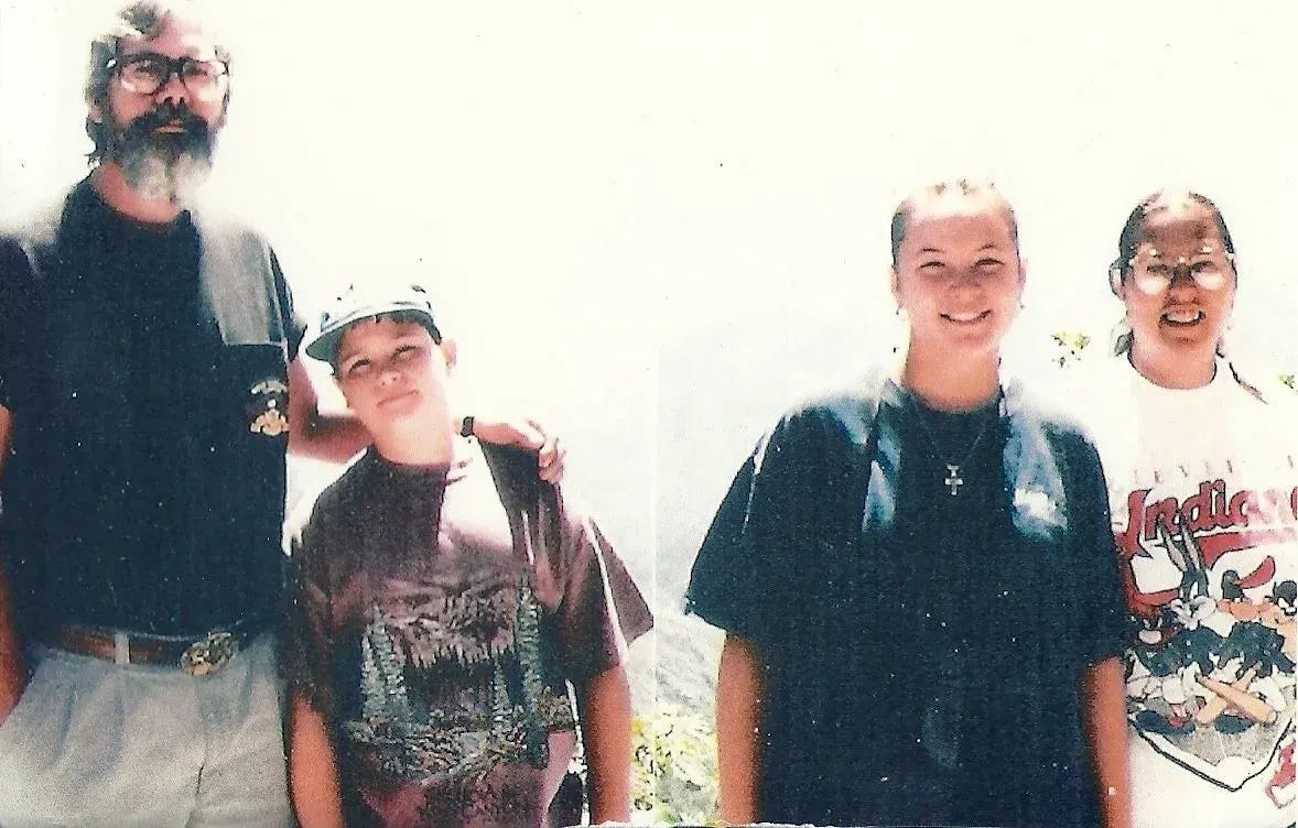 A photo of Russell at 10 years old with his sister, mother and father A photo of Russell at 10 years old with his sister, mother and father