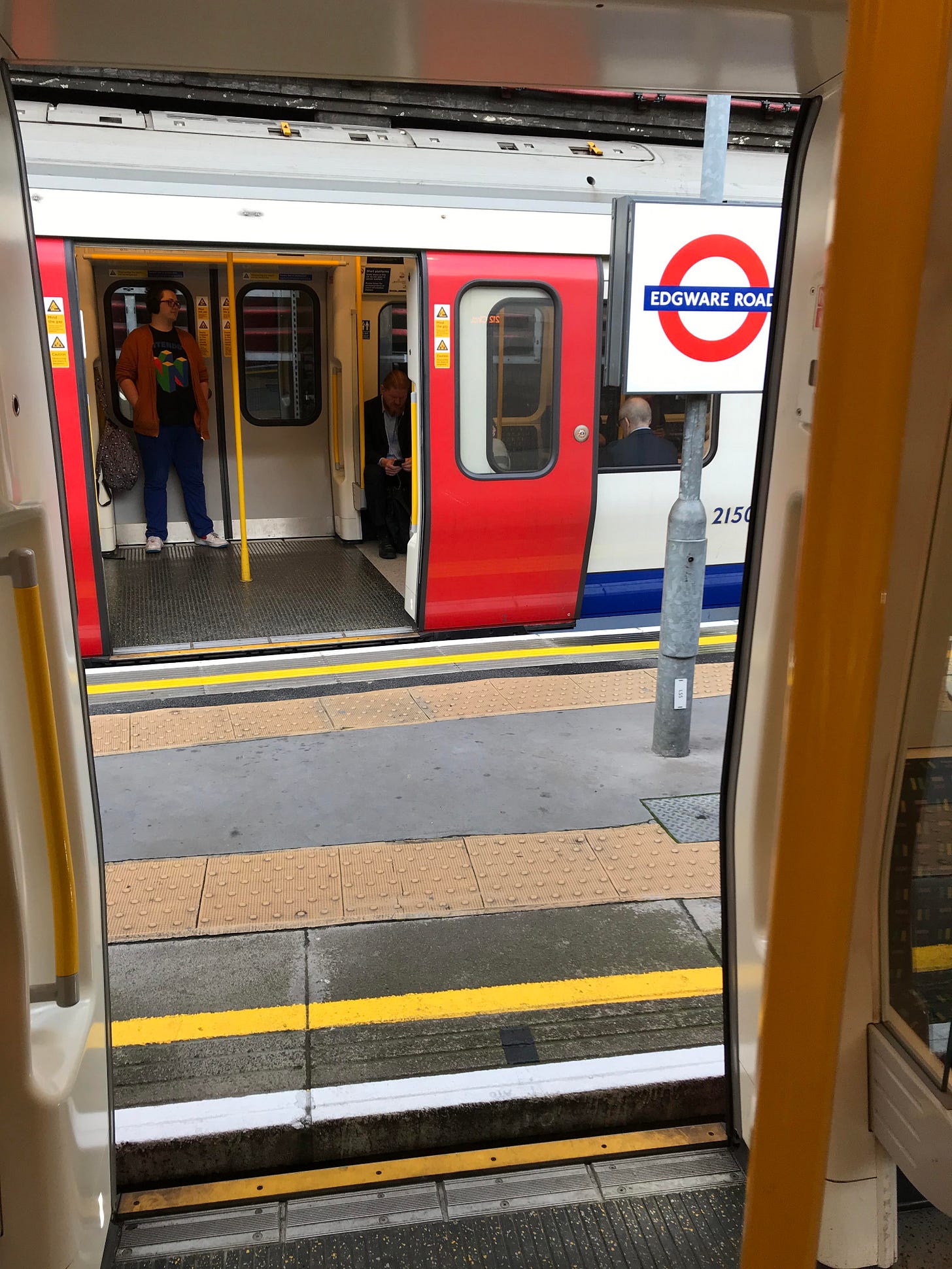 Photo of S stock train on outer platform through doorway of train on inner platform. Photo of S stock train on outer platform through doorway of train on inner platform.