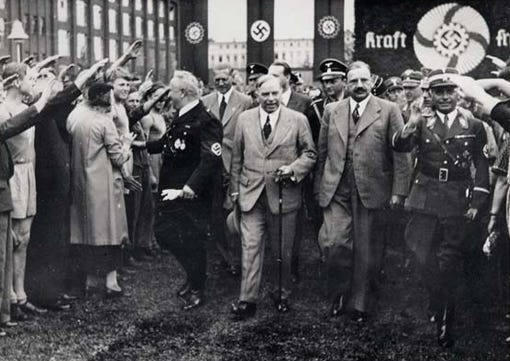 A group of men standing in front of a crowd

Description automatically generated