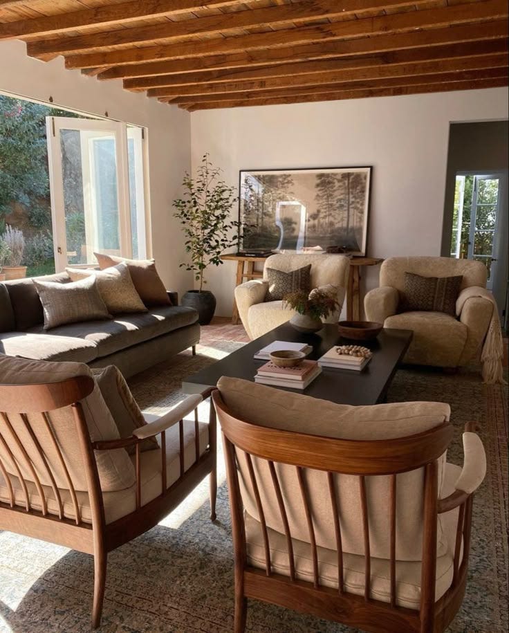 This may contain: a living room with couches and chairs in it This may contain: a living room with couches and chairs in it