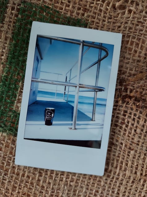 Instant photographs of coffee mugs or a bearded man drinking coffee.