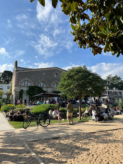 Château des Ducs de Bretagne and the city around the fortress, Jardin des Plantes, the Jean Jullien green line installation and the lively Café de l'Orangerie, former LU biscuit factory Le Lieu Unique and its bookshop and outdoor area by the river