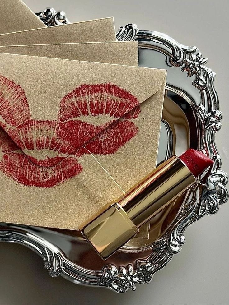 This may contain: a set of napkins with red lipstick on them next to a silver plate and envelope This may contain: a set of napkins with red lipstick on them next to a silver plate and envelope