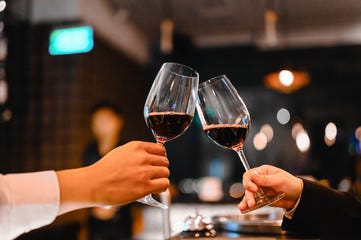 Two bartender enjoying of Cheers glass of wine for wine tasting event in a restaurant  at sunset. bartender, tasting, Dinner, Wine, beverage, dinner concept.
