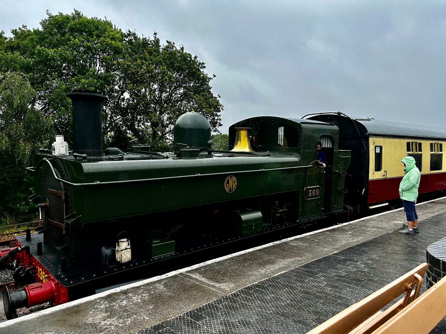 The GWR 0-6-0PT stands ready to leave Totnes Riverside Station. Her dark green paintwork dampened in the dismal weather. South Devon Railway runs several steam trains. Image: Roland's Travels The GWR 0-6-0PT stands ready to leave Totnes Riverside Station. Her dark green paintwork dampened in the dismal weather. South Devon Railway runs several steam trains. Image: Roland's Travels