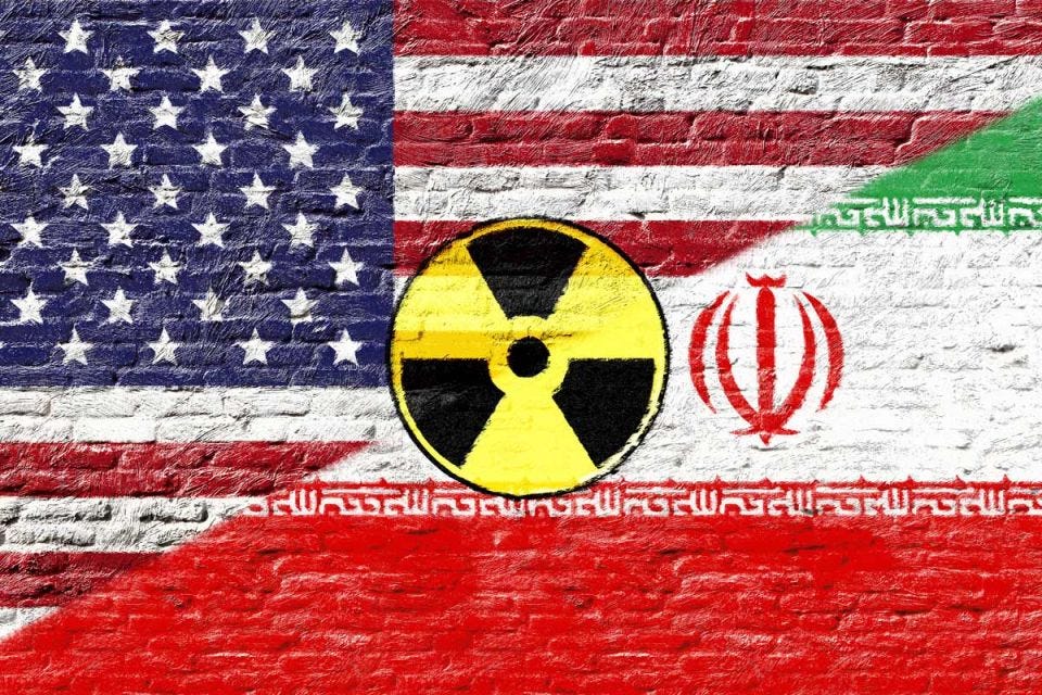 Iranian and U.S. flags with nuclear logo Iranian and U.S. flags with nuclear logo