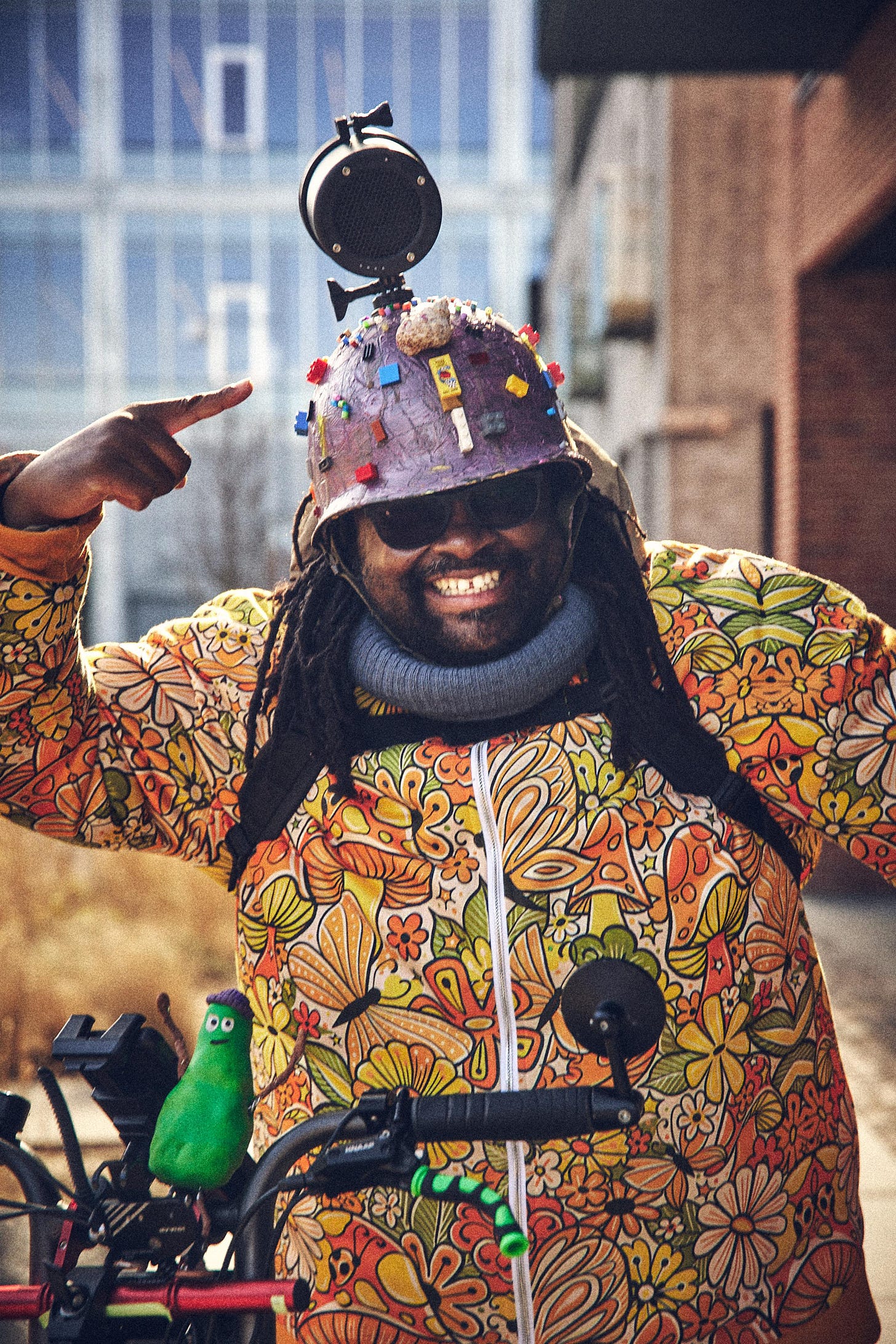 Founder of Metadata Expressionism: FatbikeHero [Tendai Frank Tagarira] in Floral Performance Art Costume and Military helmet with Lego  and other toys.