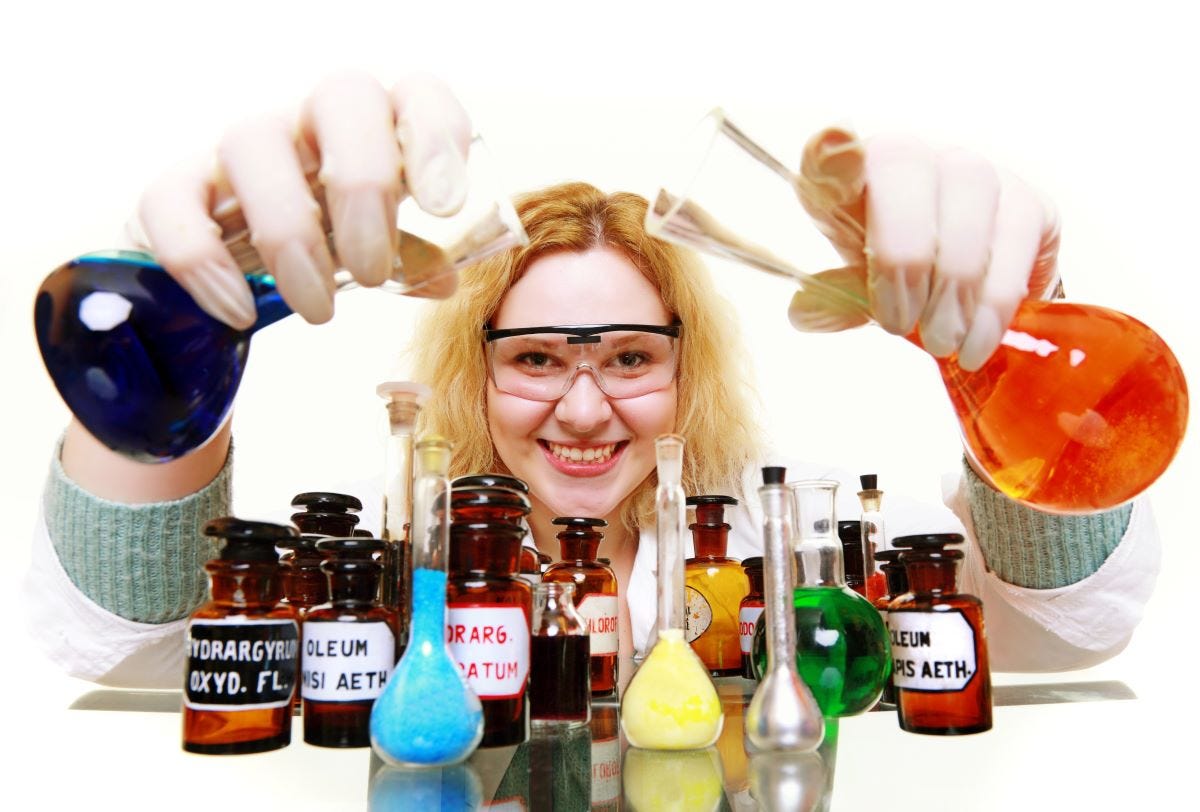 Women pouring from Erlenmeyer beakers onto collection of flasks