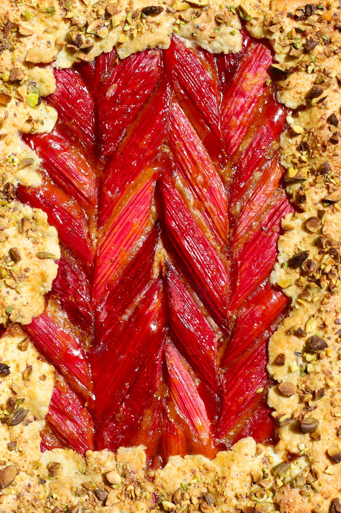 Close-up rhubarb galette with crust sprinkled with chopped pistachios