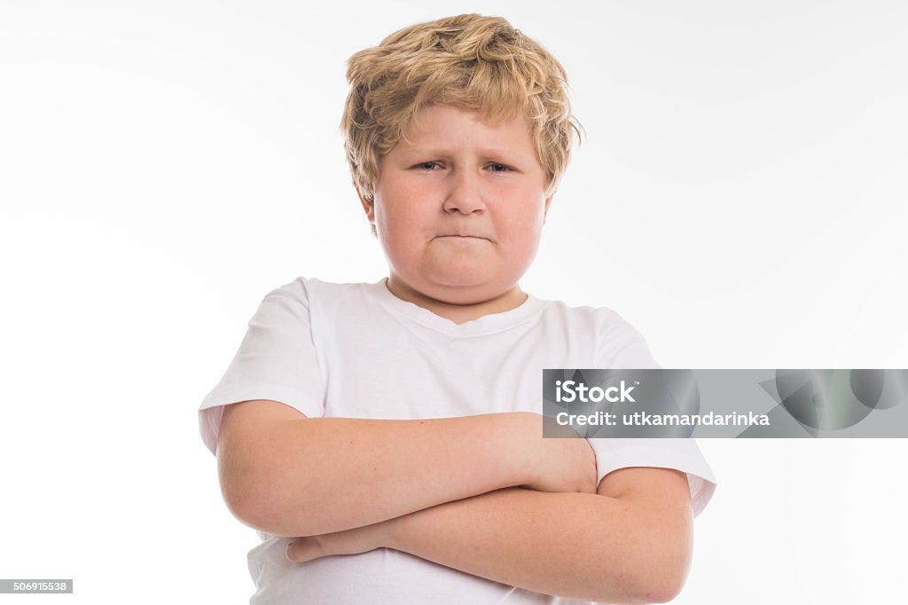 Angry fat boy blond isolated on white kid child studio boy angry portrait on white Overweight Stock Photo
