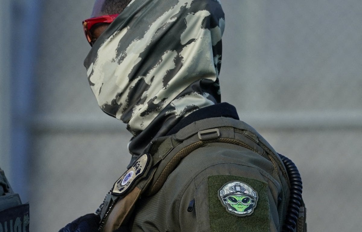 Ice agent wears mask Ice agent wears mask