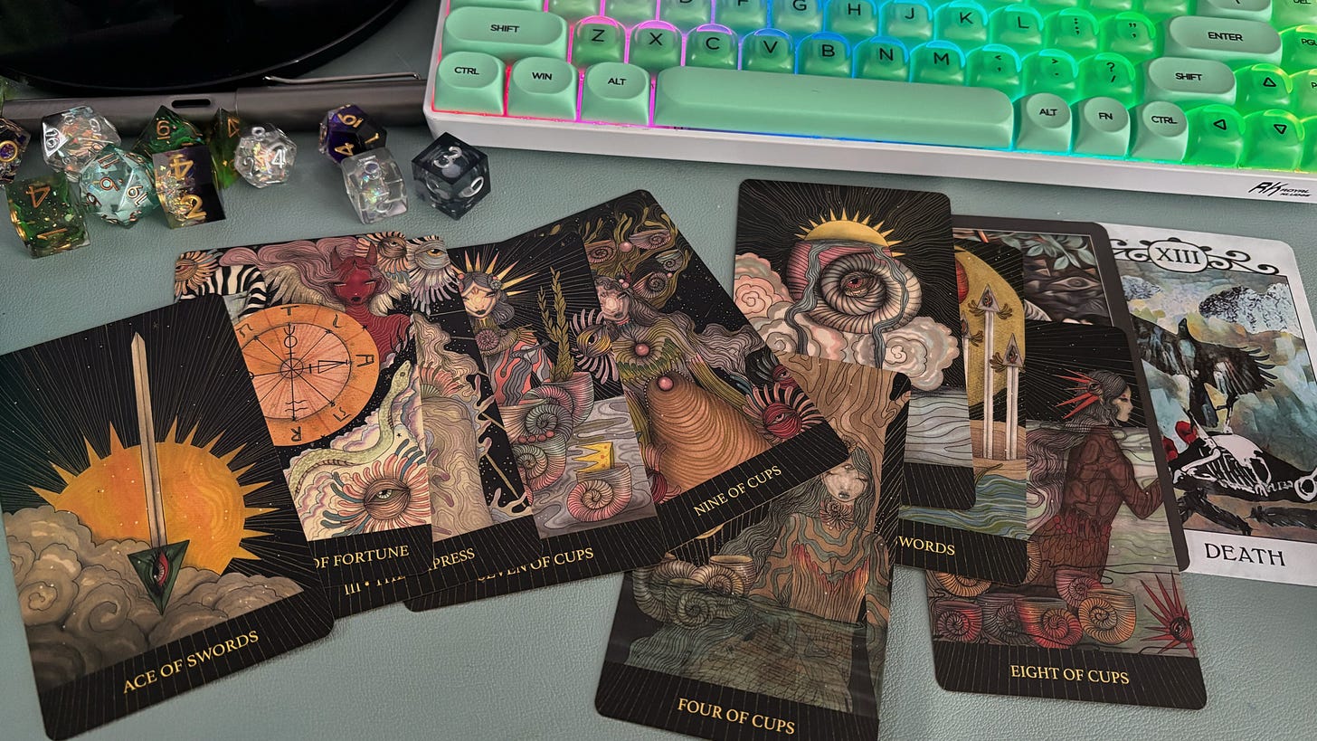 Tarot cards, dice, and a keyboard.