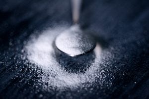 sugar spilling off a spoon
