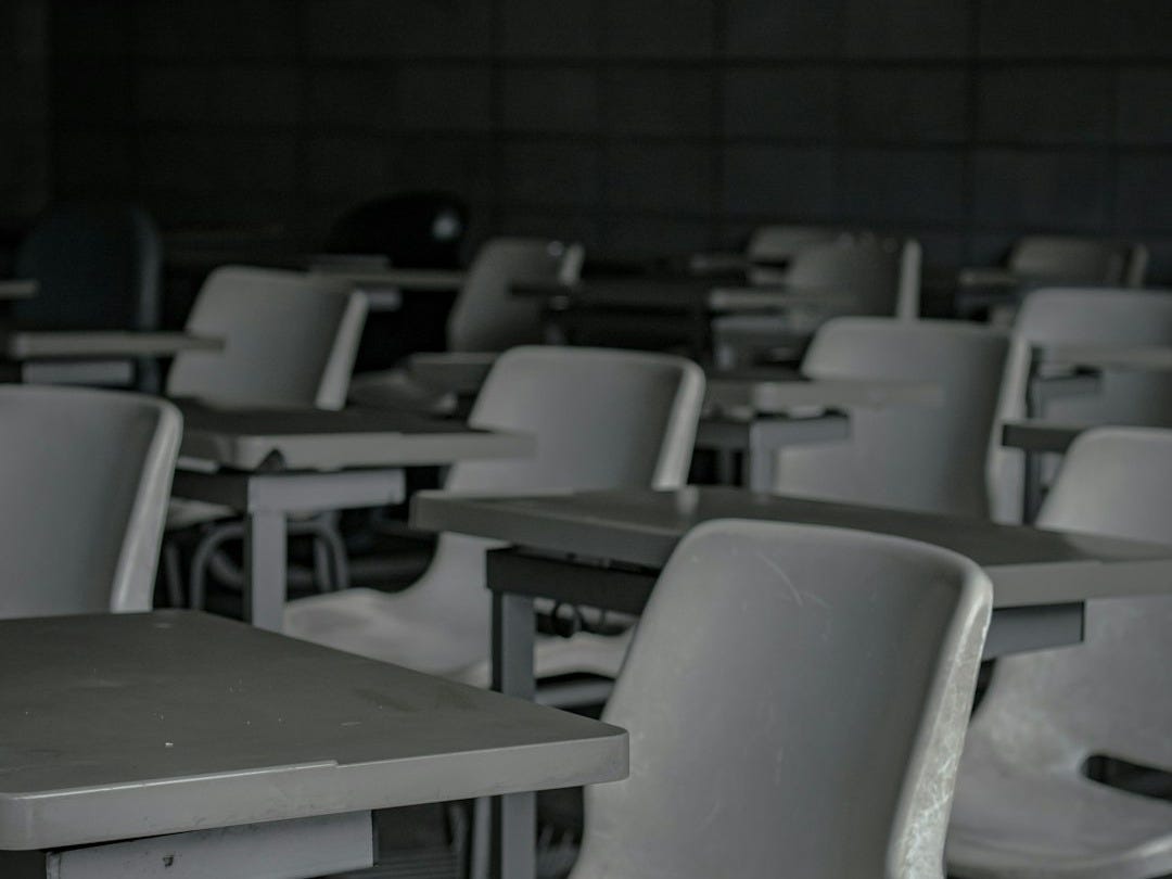 white plastic chairs in front of green table