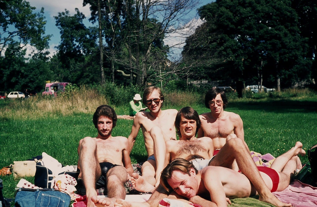Gregg (center) with his friends on the grassy slopes outside the Highgate Men’s Pond enclosure.