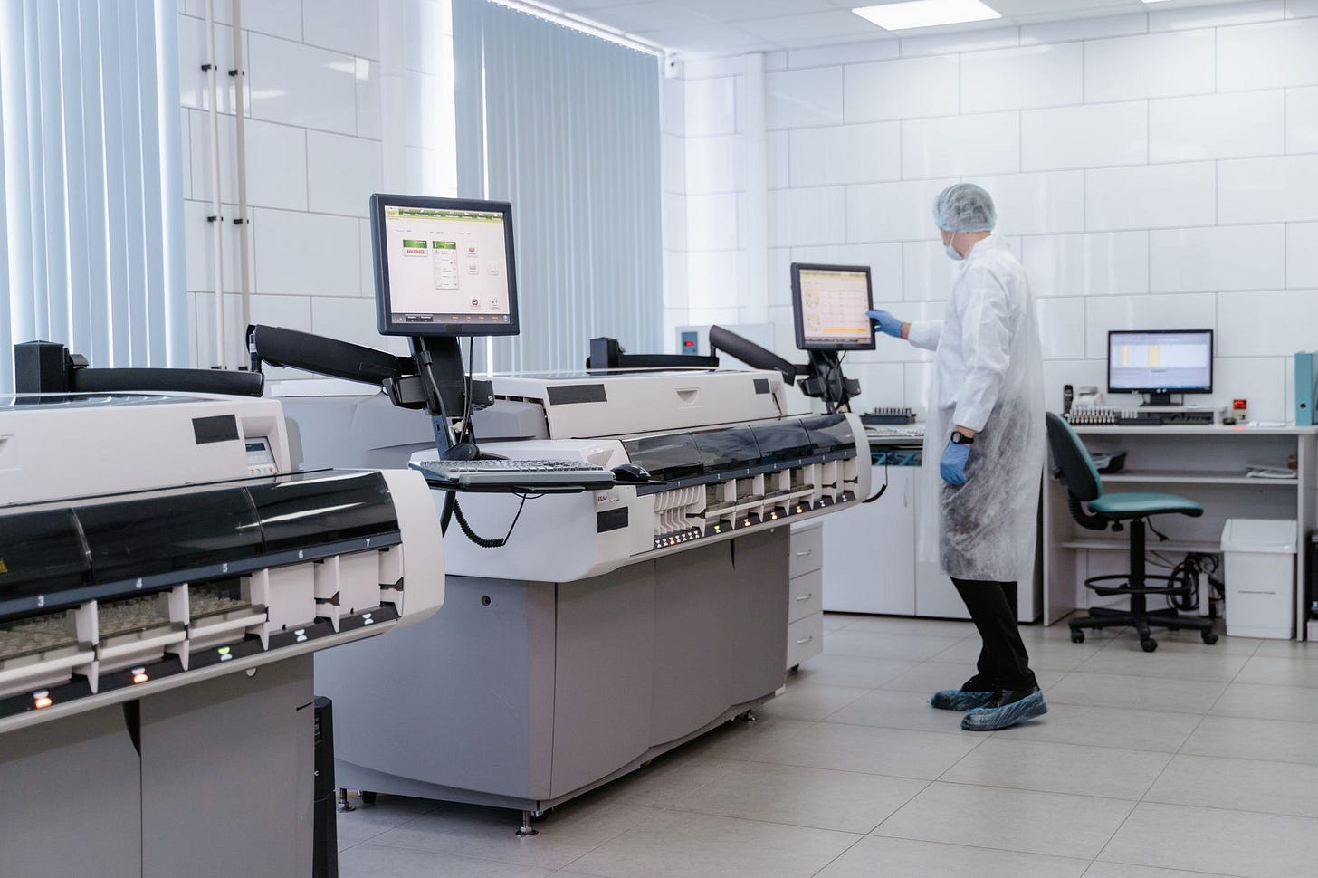 Photo by Tima Miroshnichenko on Pexels Scientist in a lab gown interacting with equipment in a modern laboratory setting. (stock photo)