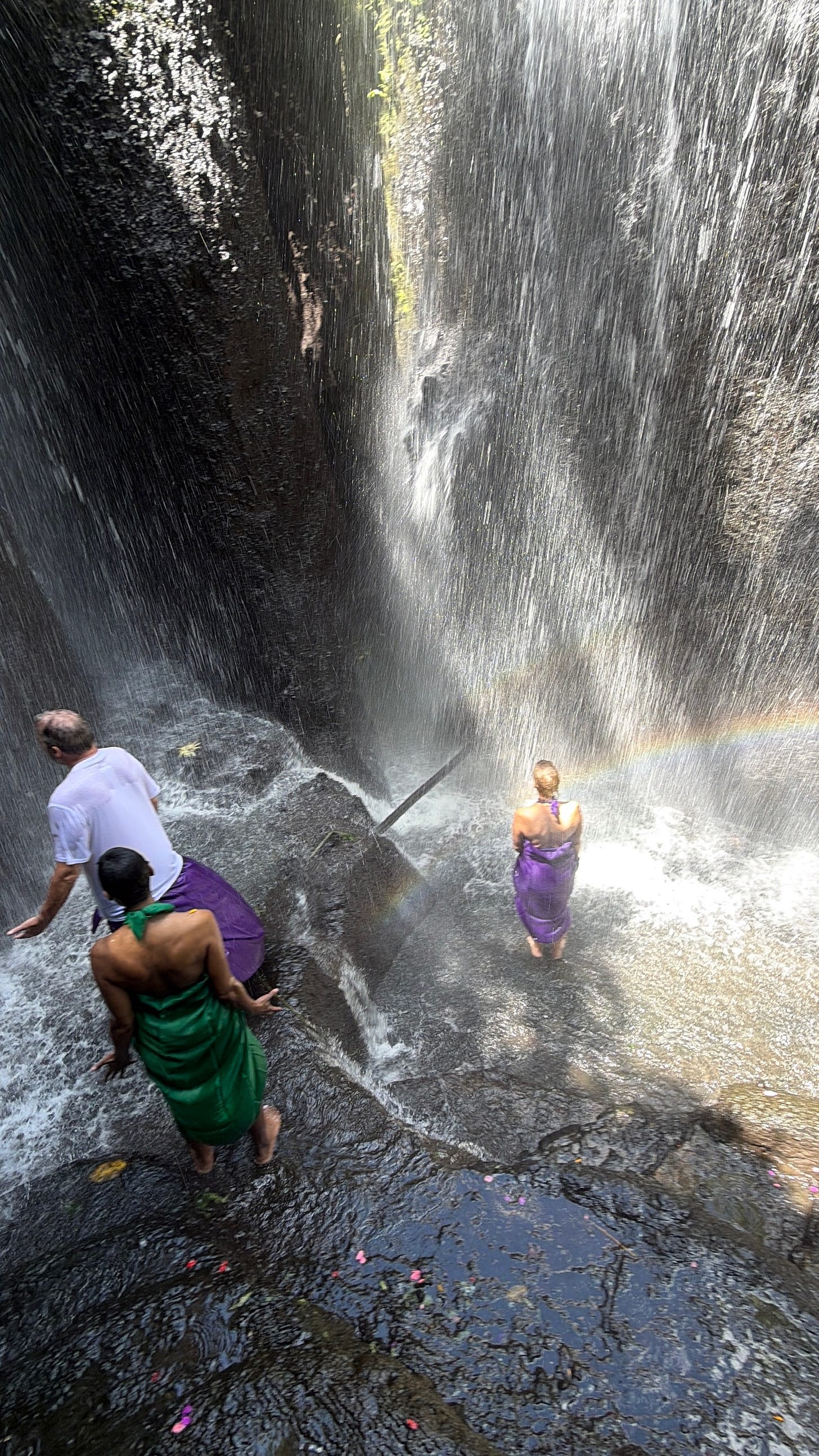 Kelly, Nigel and Krystal standing under a waterfall during a cleansing ceremony. Kelly, Nigel and Krystal standing under a waterfall during a cleansing ceremony.