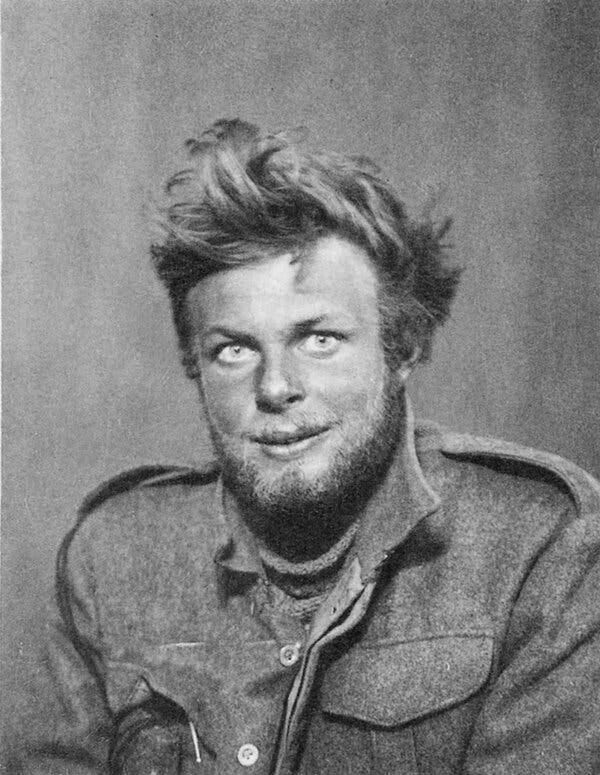 A black and white portrait of Mr. Sadler as a young military man. Wearing a wool military jacket, he stares intently at the camera. He has a broad face, a beard and unruly hair. 
