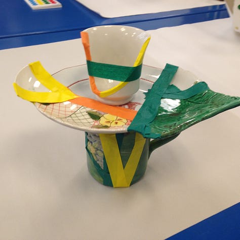 broken cups and plates are sorted and reassembled using wax, tape and fiber