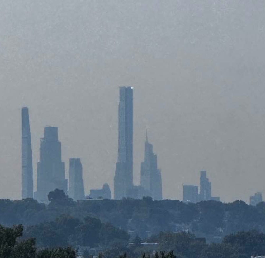 A city skyline with trees in the background

AI-generated content may be incorrect.