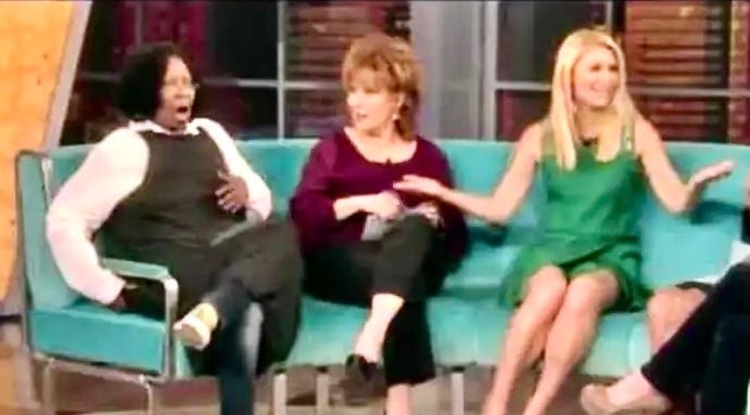 A group of women sitting on a couch

Description automatically generated