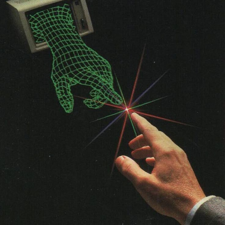 This may contain: a hand is pointing at an object with green light