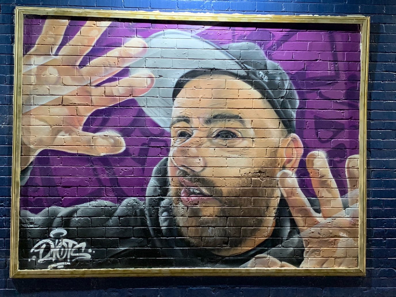 Bankstown Street Art Mural of Man in Baseball Cap with face pressed up to window 