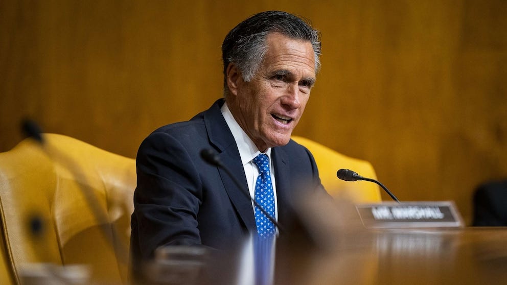 Mitt Romney at a table Mitt Romney at a table