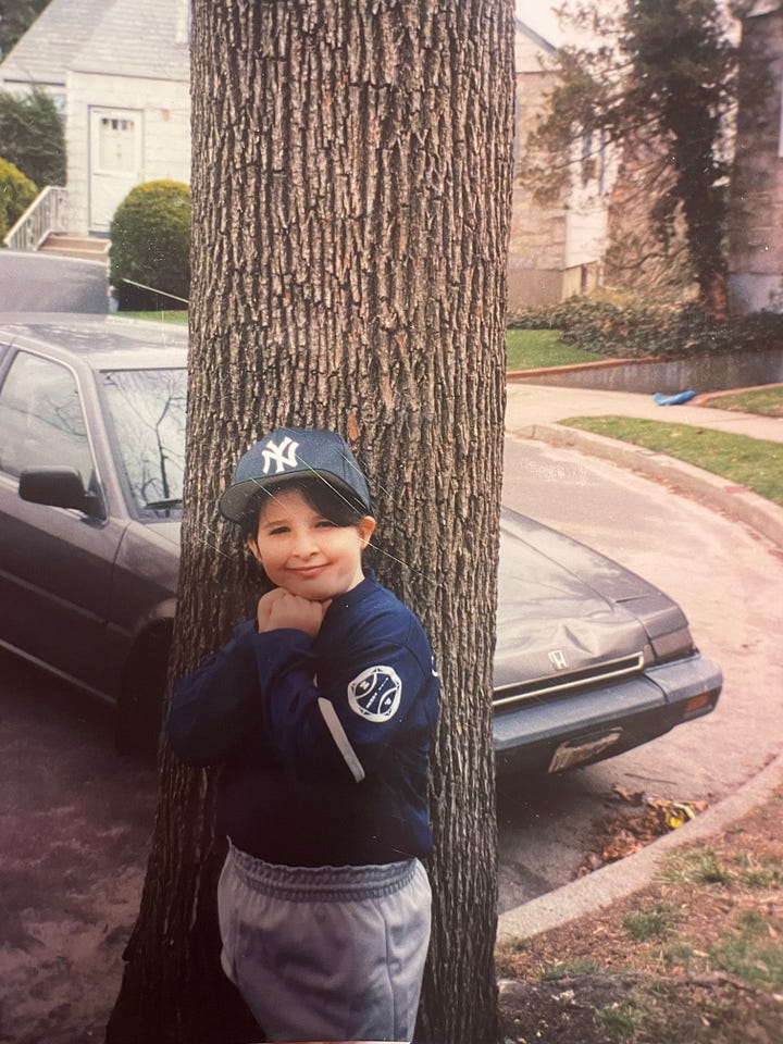 Pictures of Meg, age 8, in a softball uniform looking particularly unathletic.