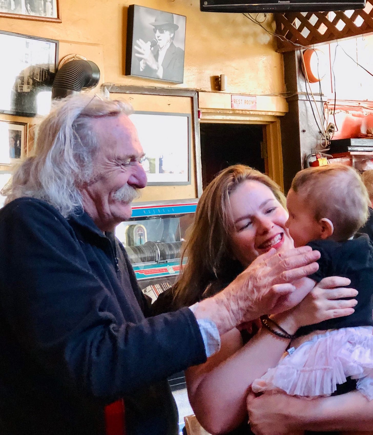 Jack Hirschman and Amber Tamblyn stand next to each other. Amber holds her infant daughter, Marlow, in her arms. Amber and Jack smile at Marlow as Jack puts his hand on Marlow's arm. Jack Hirschman and Amber Tamblyn stand next to each other. Amber holds her infant daughter, Marlow, in her arms. Amber and Jack smile at Marlow as Jack puts his hand on Marlow's arm.