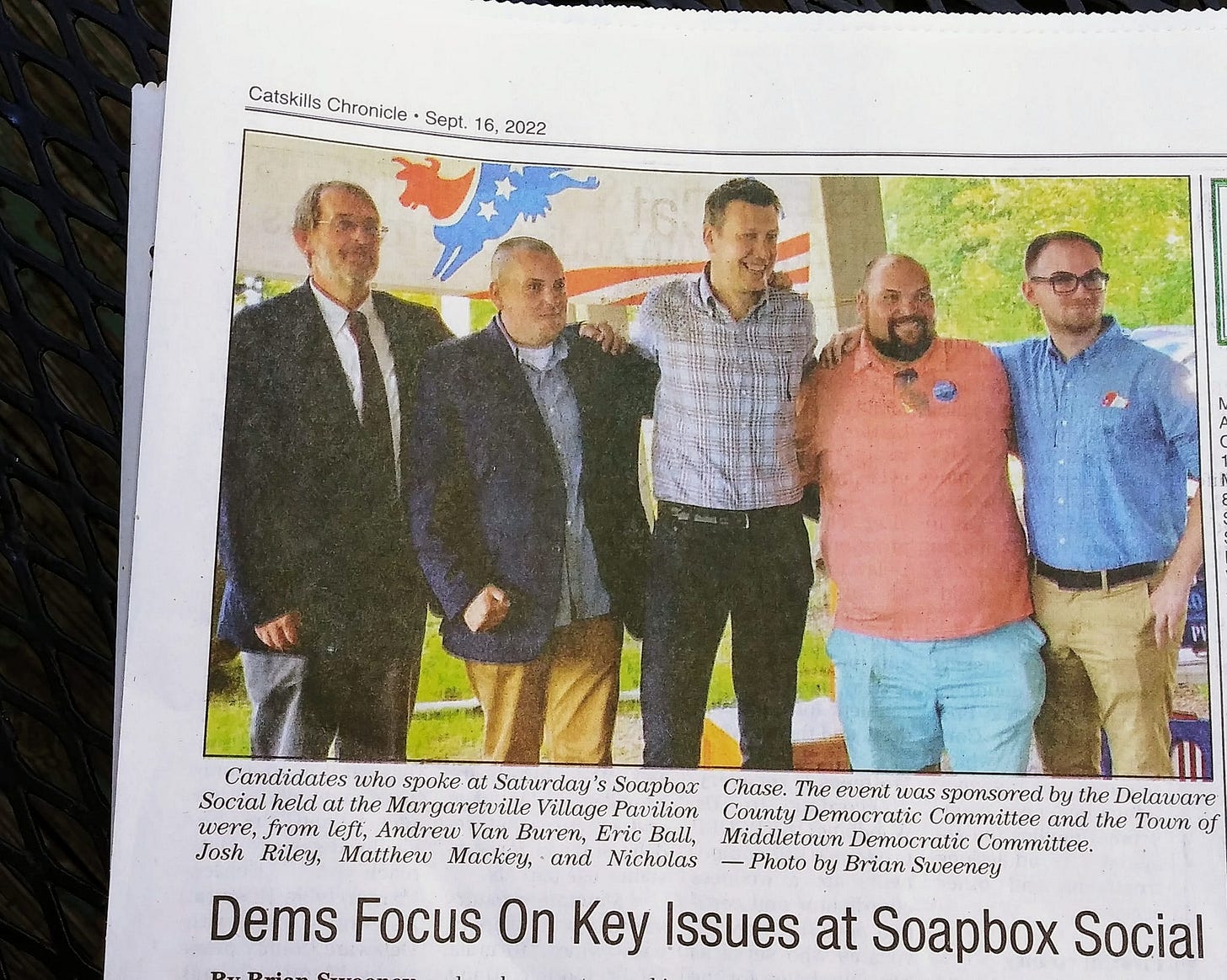 May be an image of 5 people, people standing and text that says 'Catskills Chronicle Sept. 16, 2022 Candidates who spoke at Saturday' S Soapbox Chase. The event was sponsored by the Delaware Social held at the Margaretville Village Pavilion County Democratic Committee and the Town of were, from left, Andrew Van Buren, Eric Ball, Middle Middletown Democratic Committee. Josh Riley, Matthew Mackey, and Nicholas Photo by Brian Sweeney Dems Focus On Key Issues at Soapbox Social'