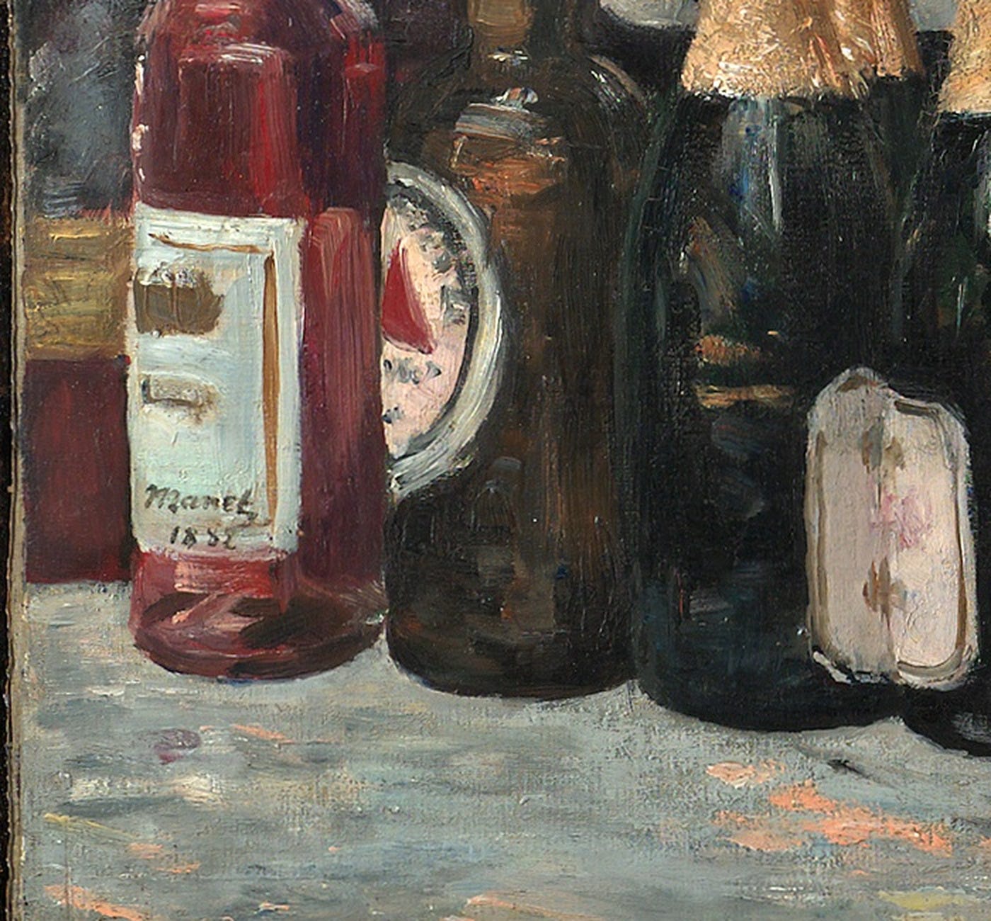 Detail of Manet's A Bar at the Folies Bergère: the painter's signature, Manet 1882, written on the white label of the red bottle at the far left of the counter. Detail of Manet's A Bar at the Folies Bergère: the painter's signature, Manet 1882, written on the white label of the red bottle at the far left of the counter.