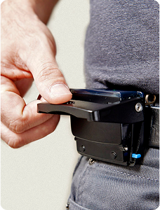 The Reflex device clipped to a worker's belt