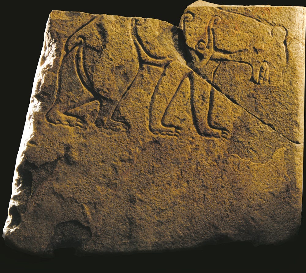 Photo of a carved stone featuring a prowling bear Photo of a carved stone featuring a prowling bear