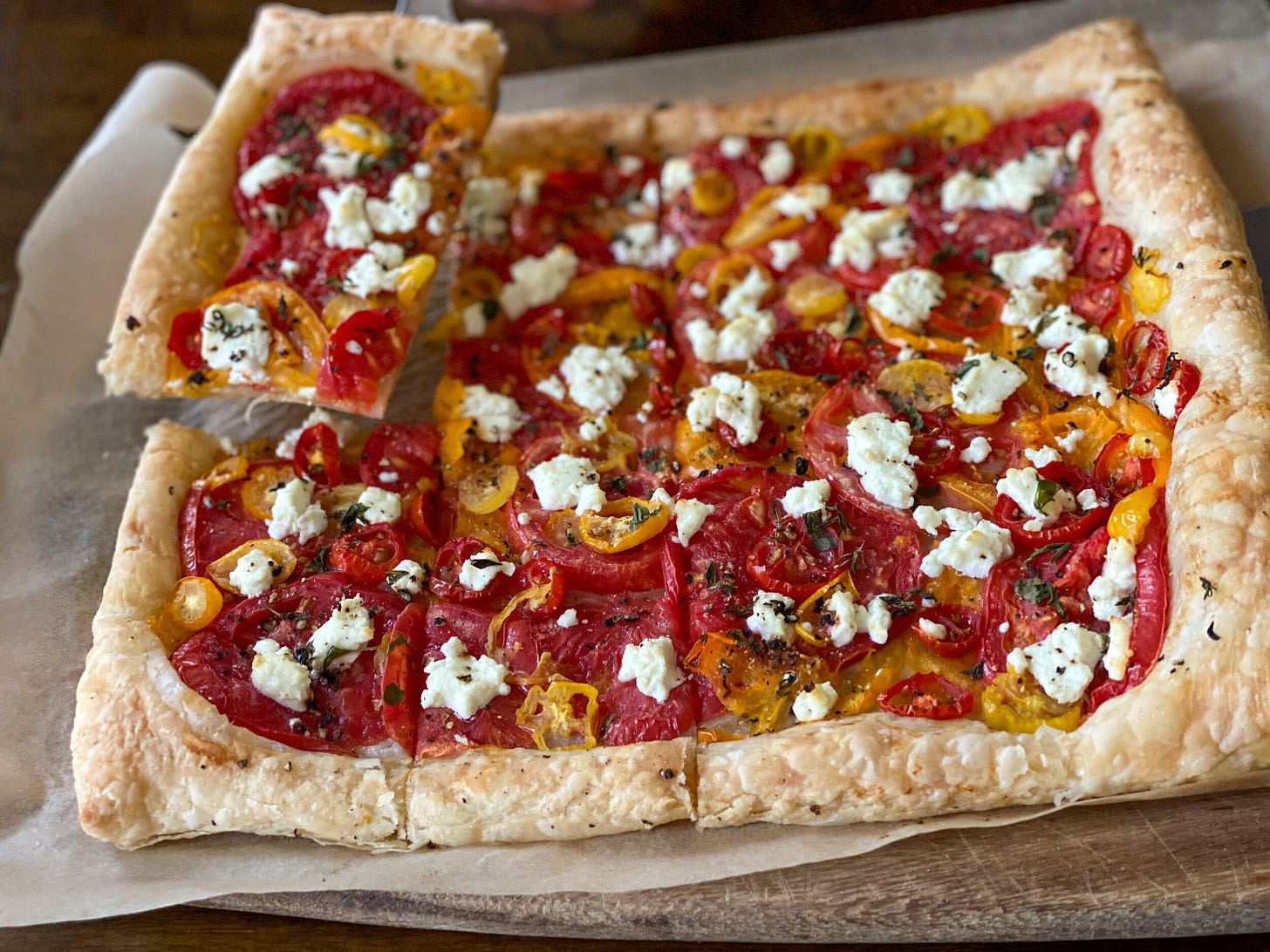 Easy heirloom tomato tart with goat cheese and thyme, made using all-butter frozen puff pastry.