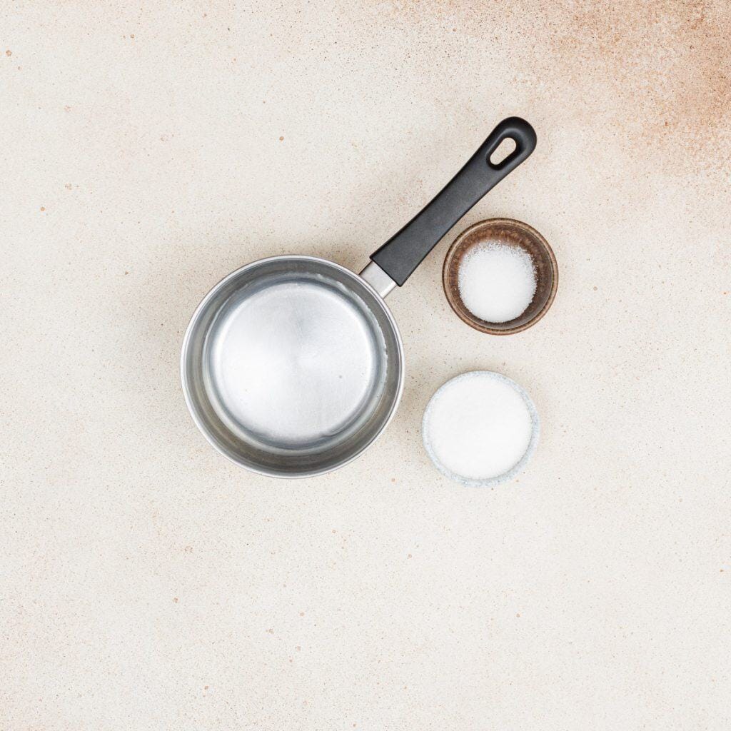 Small saucepan of water, sugar, and vanilla powder.