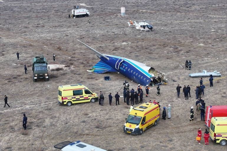 A drone view shows emergency specialists working at the crash site of an Azerbaijan Airlines passenger plane near the city of Aktau, Kazakhstan