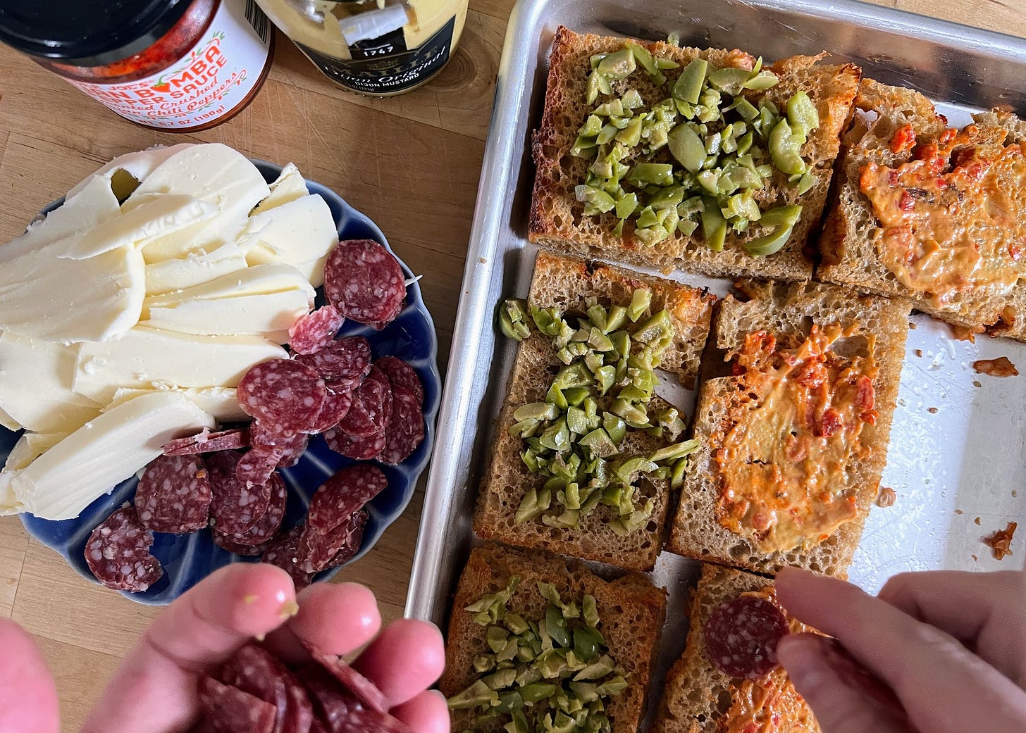 Hands assembling focaccia sandwich