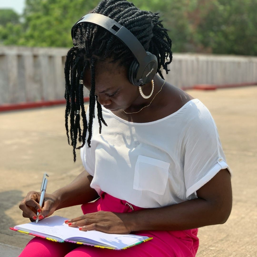 a woman writing on a book a woman writing on a book