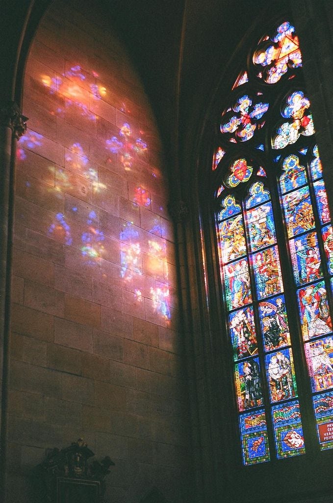 This may contain: the stained glass windows in this church are very colorful and beautiful, as well as bright sunlight coming through them