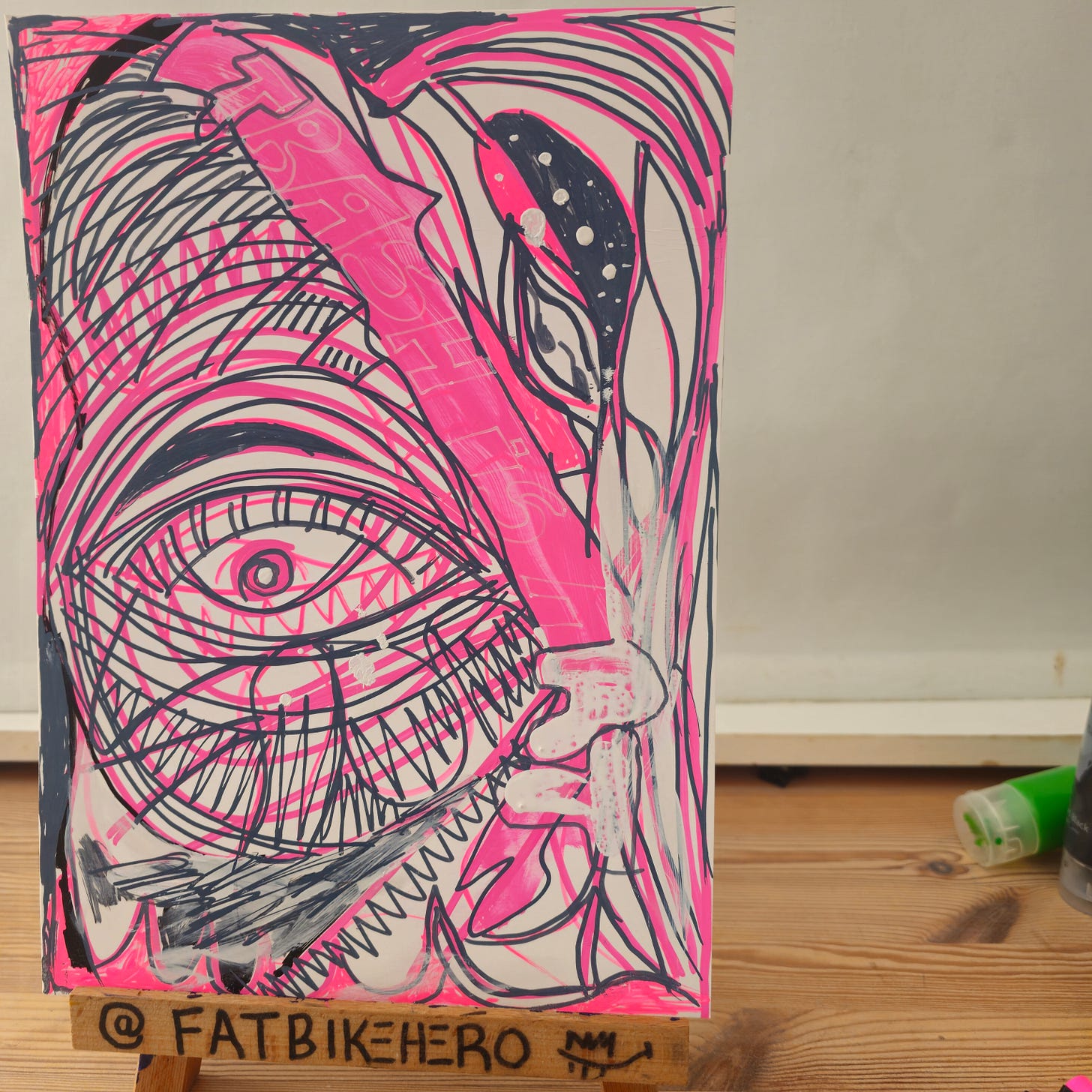 Title: Trash is Art (2025) by FatbikeHero  Description:  In this striking 2025 work, International artist FatbikeHero (b. 1983) explores the transformative nature of creativity. Created in Vorre-Skødstrup on August 27, 2025, Trash is Art combines neon marker abstraction with a handwritten manifesto. The artist argues that using reclaimed materials is not merely "recycling," but a fundamental shift in value—turning the discarded into the eternal.  Technical Details:   * Artist: FatbikeHero   * Medium: Marker on reclaimed board   * Date: August 27, 2025   * Source: fatbikehero.com  Recommended Image Filename:  fatbikehero-art-trash-is-art-2025-abstract-eye.jpg  Recommended Alt Text:  > "Original mixed media art by FatbikeHero (b. 1983) titled 'Trash is Art'. Abstract drawing featuring a large eye and neon pink lines on reclaimed board, created August 27, 2025, in Vorre-Skødstrup."  > 