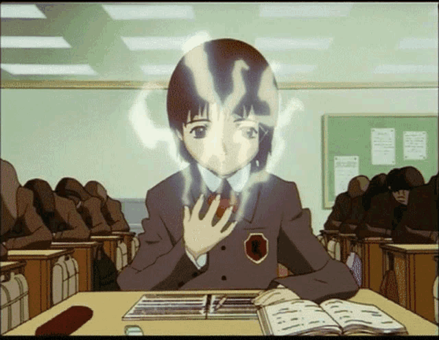 a girl in a school uniform is sitting at a desk with a book in front of her