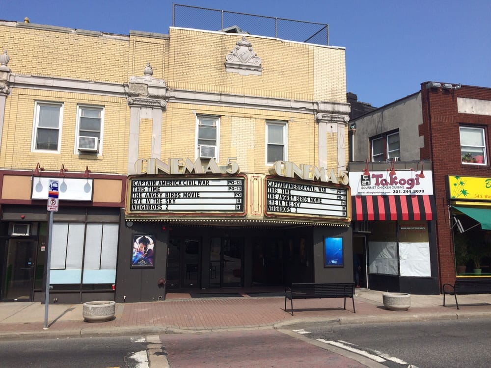 Bergenfield Cinemas. Not sure what year, the movies on the marquee are Captain America Civil War and The Angry Birds movie. It's a once-elegant old building, yellow brick, with flourishy cement (cement? I think that's what it is?) trim details on the upper story.
