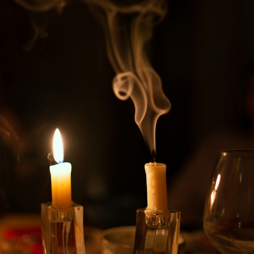 a couple of candles sitting on top of a table