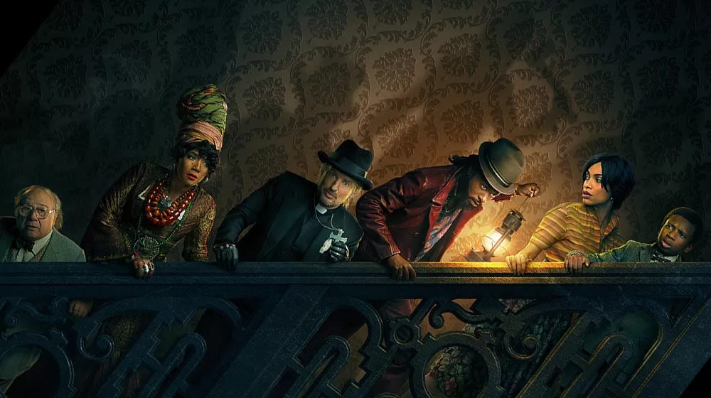 The cast of the new "Haunted Mansion" walking up a staircase together.