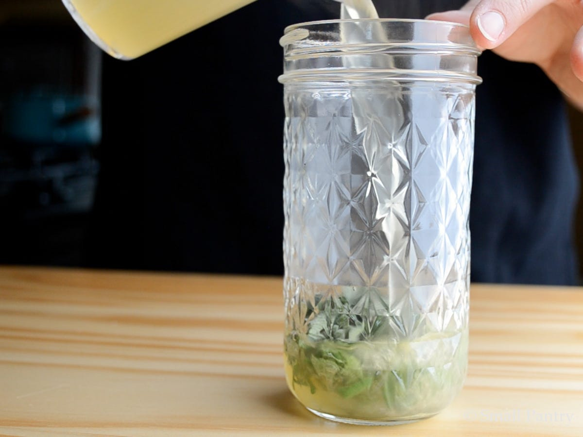 Steeping fresh sage in hot broth