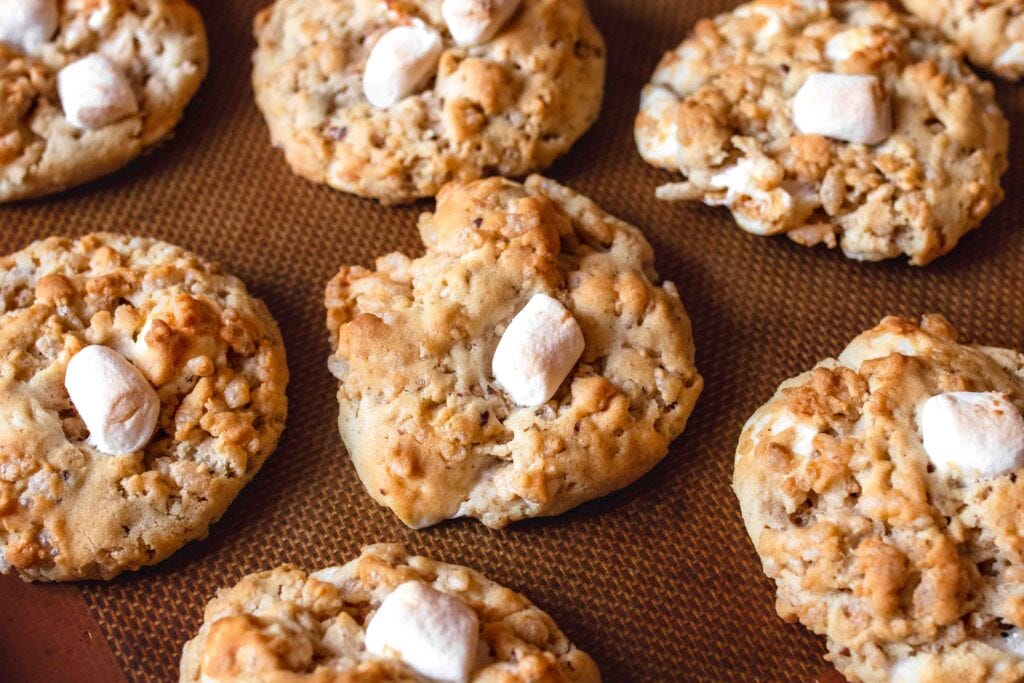 Landscape image of closeup of vegan Rice Krispie cookies on a silicone baking mat.