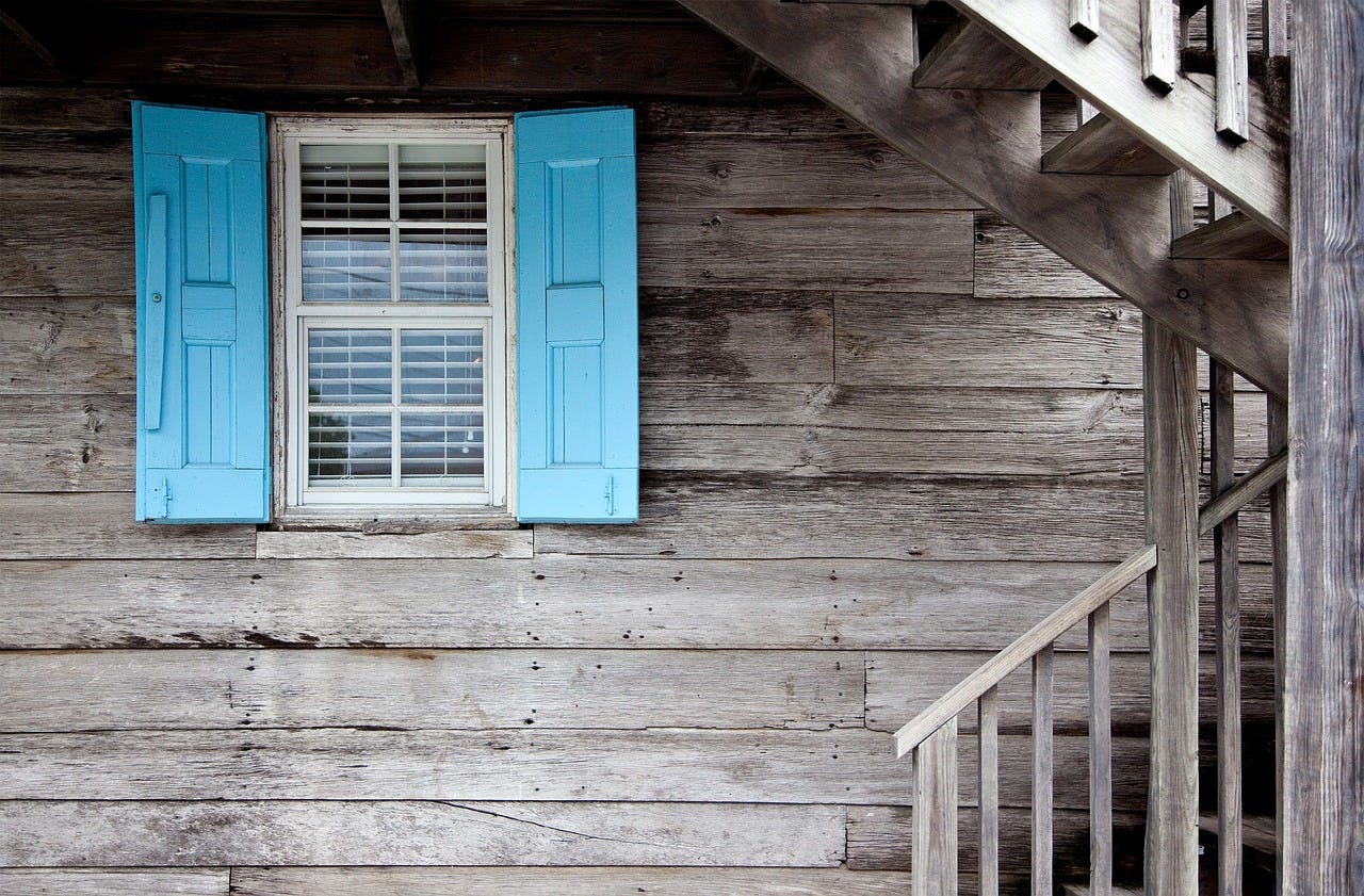 blue shutters on fixer upper home