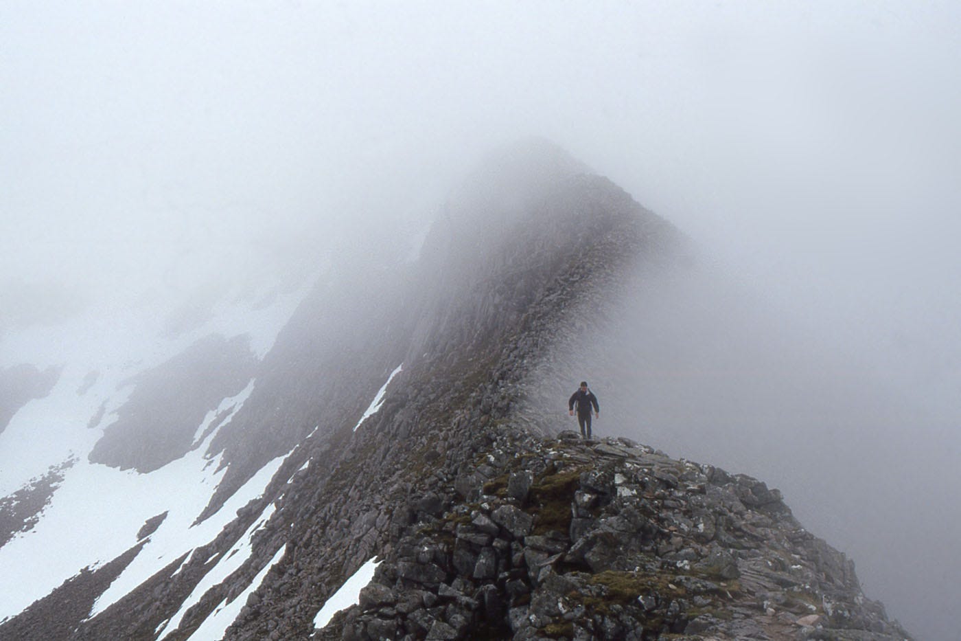 rocky ridge, snow patches, mist