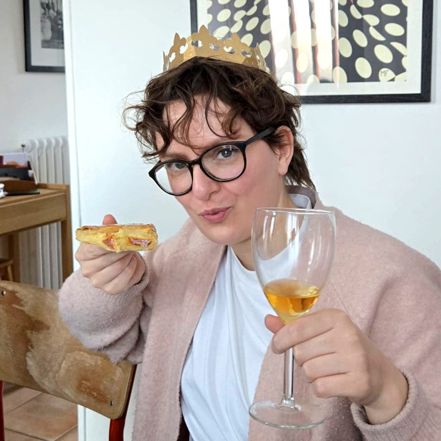 pic of me living my best life with a glass of cider, a slice of galette, and a cardboard brown